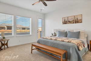 Bedroom with ceiling fan and light carpet