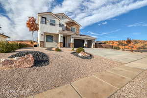 View of front of home with a garage and a balcony