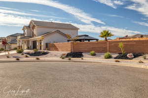 View of property exterior with a gazebo and a garage