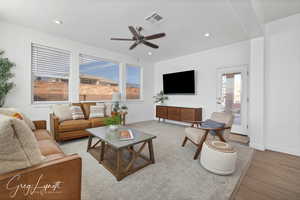 Living room featuring light hardwood / wood-style flooring and ceiling fan