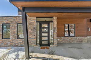 View of snow covered property entrance