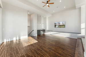 Unfurnished living room featuring ceiling fan and hardwood / wood-style floors