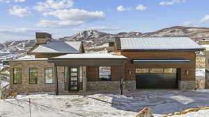 View of front of property featuring a mountain view and a garage