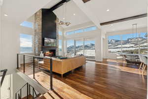 Living room featuring a mountain view, plenty of natural light, and hardwood / wood-style flooring