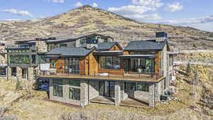 Rear view of house with a mountain view and a balcony