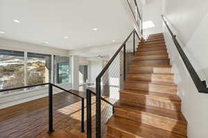 Staircase featuring wood-type flooring