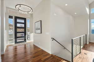 Entryway with a chandelier, hardwood / wood-style floors, and high vaulted ceiling