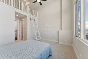 Bedroom featuring light colored carpet and ceiling fan