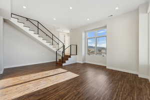 Unfurnished living room with dark hardwood / wood-style floors