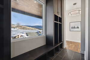 Mudroom featuring wood ceiling, a mountain view, dark hardwood / wood-style flooring, and a chandelier