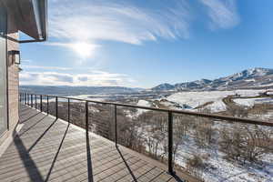 Snow covered back of property featuring a mountain view