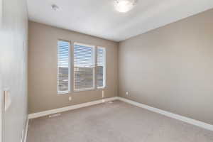 Spare room with light colored carpet