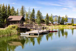 Dock area featuring a water and mountain view