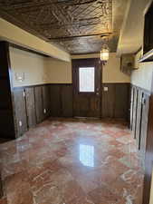 Basement room featuring wooden walls and a unique touch