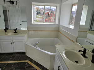 Master Bathroom featuring vanity and tiled tub