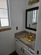 1/2 Bathroom with plenty of natural light and vanity