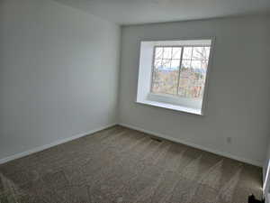 Bedroom 3 with carpet flooring and a textured ceiling