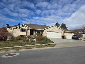 View of front of home featuring a front yard and a garage