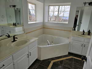 Master Bathroom with vanity and a jetted tub to relax in