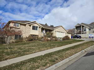 View of front facade featuring a front yard and a garage