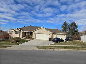 Ranch-style house with a front lawn and a garage