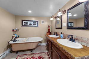 Bathroom featuring tile patterned flooring, vanity, and a bathing tub