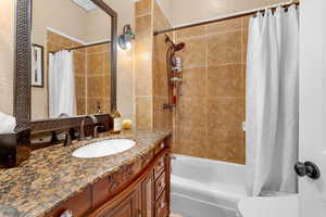 Full bathroom with vanity, toilet, and shower / tub combo with curtain