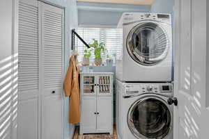 Laundry room featuring stacked washer / drying machine