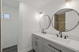 Bathroom with hardwood / wood-style floors and vanity