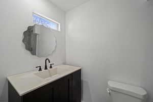 Bathroom featuring vanity and toilet