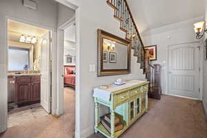 Corridor with light colored carpet and sink