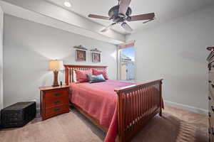 Bedroom with light carpet and ceiling fan