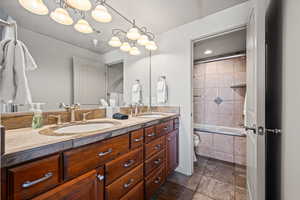 Bathroom featuring vanity and tiled shower / bath