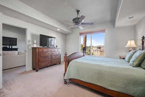 Bedroom featuring light colored carpet and ceiling fan