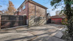 View of side of property with ac unit and a patio area