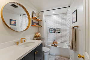 Full bathroom featuring vanity, toilet, and shower / tub combo