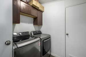 Washroom with cabinets and independent washer and dryer