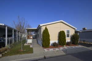 View of property exterior with a carport