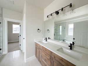 Full bathroom with a garden tub, a sink, a shower stall, and double vanity