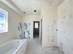 Bathroom featuring a relaxing tiled tub