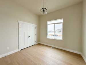 Interior space featuring light wood-style floors, baseboards, and a closet