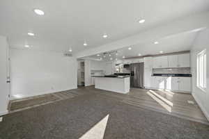 Unfurnished living room with dark wood-type flooring