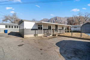 View of front of property featuring a mountain view and a porch