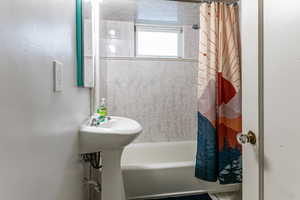 Bathroom with shower / bath combination with curtain