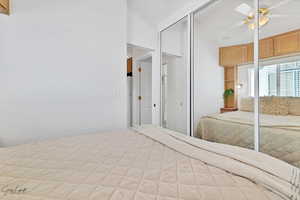 Bedroom featuring ceiling fan and lofted ceiling