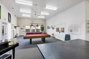 Playroom featuring a textured ceiling, carpet floors, ceiling fan, and billiards