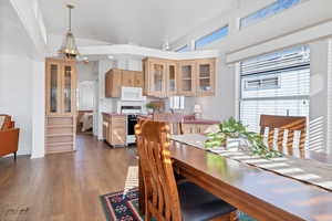 Dining area with an inviting chandelier and dark wood-type flooring