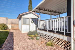 Exterior space featuring a shed and a deck