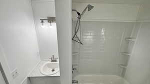 Bathroom with vanity and tiled shower / bath