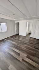 Empty room featuring dark hardwood / wood-style floors